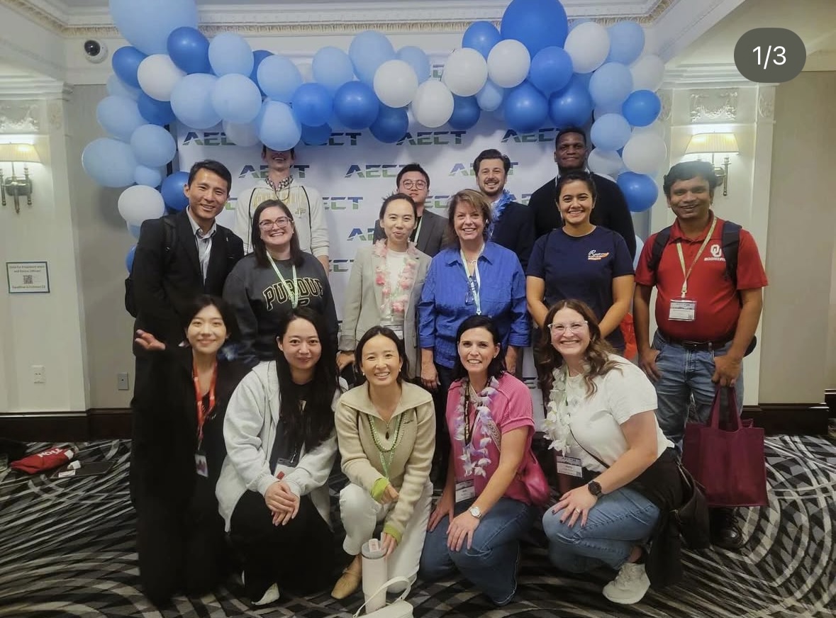 Belle Li with colleagues at an AECT community gathering